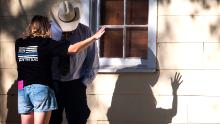A woman prays with a man after the shooting.