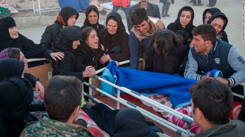 Iranians mourn over the body of a victim following a 7.3-magnitude earthquake in Sarpol-e Zahab in Iran's western province of Kermanshah.