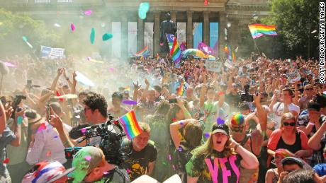 MELBOURNE, AUSTRALIA - NOVEMBER 15:  People in the crowd celebrate as the result is announced during the Official Melbourne Postal Survey Result Announcement at the State Library of Victoria on November 15, 2017 in Melbourne, Australia. Australians have voted for marriage laws to be changed to allow same-sex marriage, with the Yes vote defeating No. Despite the Yes victory, the outcome of Australian Marriage Law Postal Survey is not binding, and the process to change current laws will move to the Australian Parliament in Canberra.  (Photo by Scott Barbour/Getty Images)