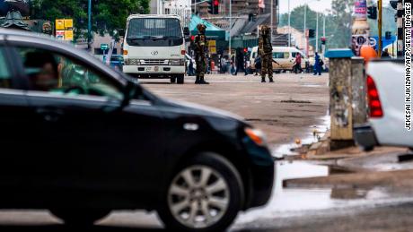 Soldiers monitor traffic in Harare on November 15 as the military set up checkpoints at key locations in the city.