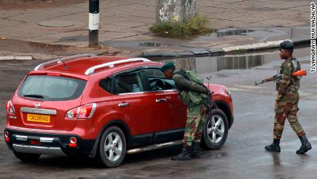 Soldiers inspect a vehicle on a road leading to Mugabe&#39;s office in Harare on November 15. The intervention came after weeks of political turmoil in which Mugabe had sacked his powerful vice president.