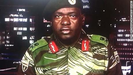 In a screen grab of a TV broadcast on the Zimbabwe Broadcasting Corp., Maj. Gen. Sibusiso Moyo reads a statement saying the military was conducting an operation to target &quot;criminals&quot; close to the President who were causing &quot;social and economic suffering.&quot; He denied a coup was underway.