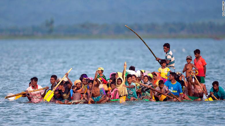 Rohingya Muslims cross the Naf River on a makeshift raft from Myanmar to Bangladesh.
