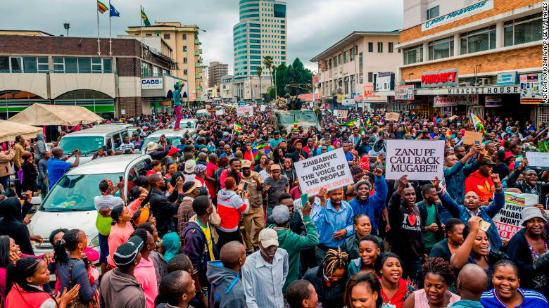 People march through a street in Harare on Saturday.