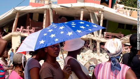 Refugees line up for food distributions by the UN in a refuge camp that opened after the 7.0 earthquake rocked Haiti in Port au Prince on January 29, 2010. (Photo by Nadav Neuhaus/Corbis via Getty Images)