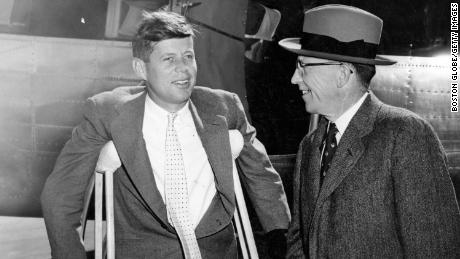 BOSTON, MA - OCTOBER 7: Democratic gubernatorial candidate Robert F. Murphy, right, and U.S. Senator John F. Kennedy arrive at Logan International Airport in Boston from Hyannis prior to a television appearance on Oct. 7, 1954. Senator Kennedy was on crutches as a result of a back injury. (Photo by William Ennis/The Boston Globe via Getty Images)