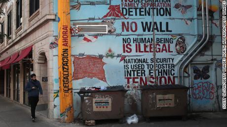  A mural voicing support for immigrants is painted along a retail strip in the Pilsen neighborhood of  Chicago.