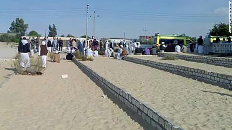 Egyptians gather outside Al Rawdah mosque, about 25 miles west of the North Sinai capital of Al-Arish, following the attack.