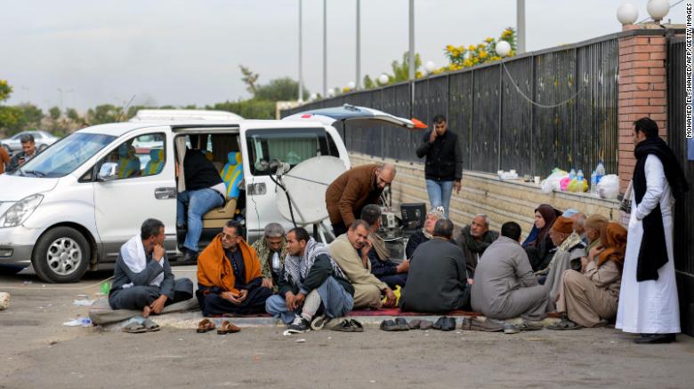 Relatives of the victims of the mosque attack sit outside a hospital Saturday in the eastern port city of Ismailia.