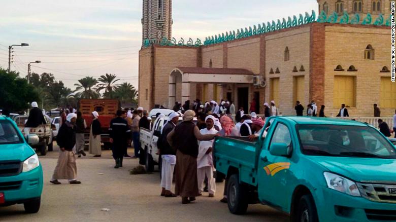 People gather at the site of the mosque attack on Friday.