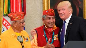 President Donald Trump, right, meets with Navajo Code Talkers Peter MacDonald, center, and Thomas Begay, left, in the Oval Office of the White House in Washington, Monday, Nov. 27, 2017. (AP Photo/Susan Walsh