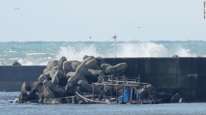 The wreckage of a boat is pictured along a sea wall in the city of Yurihonjo, Akita prefecture on November 24, 2017.