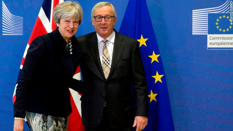 European Commission President Jean-Claude Juncker, right, greets British Prime Minister Theresa May in Brussels.