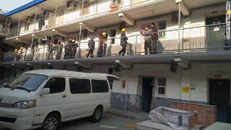 Demolition crews wield sledgehammers as they enter a residential compound to enforce an eviction.