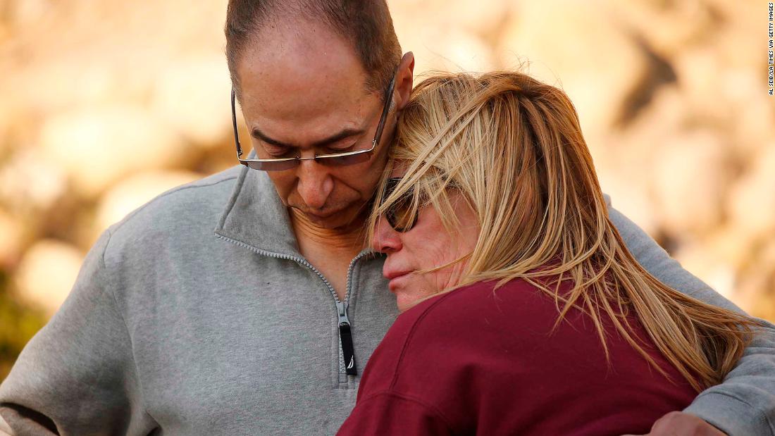 Antoine Hanna comforts his wife, Tammy, after firefighters saved their home in Ventura on December 5.