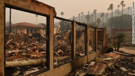 A wall stands in the burnt out Vista del Mar Hospital after the Thomas wildfire swept through Ventura, California on December 6, 2017.
California motorists commuted past a blazing inferno Wednesday as wind-whipped wildfires raged across the Los Angeles region, with flames  triggering the closure of a major freeway and mandatory evacuations in an area dotted with mansions. / AFP PHOTO / Mark RALSTON