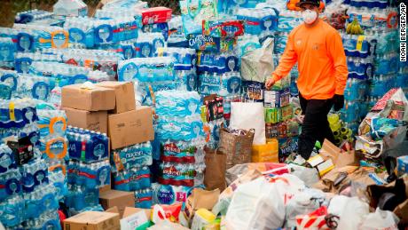 A volunteer passes supplies donated to Thomas Fire evacuees in Ventura, Calififornia.