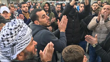 Protesters gather in al-Manara square in Ramallah on Thursday morning.