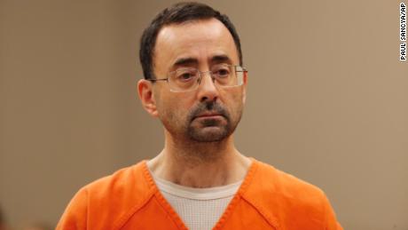 FILE - In this Nov. 22, 2017, file photo, Dr. Larry Nassar, appears in court for a plea hearing in Lansing, Mich. Nassar, an elite Michigan sports doctor who possessed child pornography and assaulted gymnasts, was sentenced Thursday, Dec. 7, 2017,  to 60 years in federal prison in one of three criminal cases that ensure he will never be free again. (AP Photo/Paul Sancya, File)