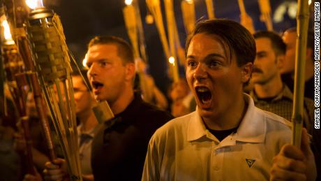 Neo-Nazis and white supremacists march and sing against demonstrators in Charlottesville.