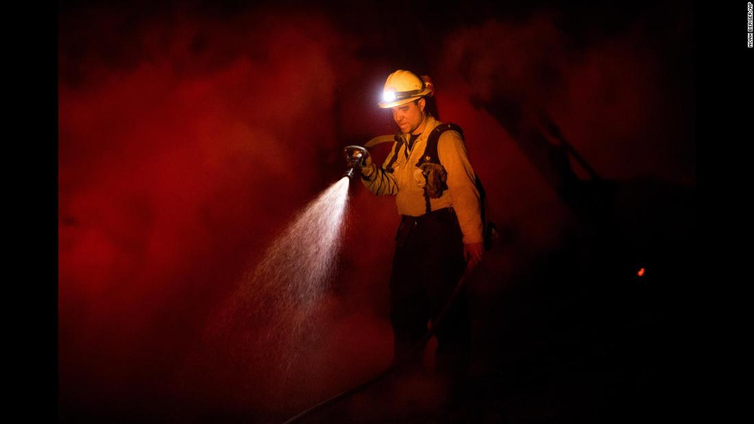 Firefighter Patrick Larsen, of San Luis Obispo, battles a wildfire in Ojai on December 7.