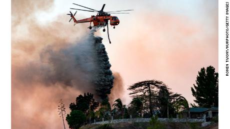 A helicopter makes a water drop over the Creek Fire on December 5, 2017, in Los Angeles.