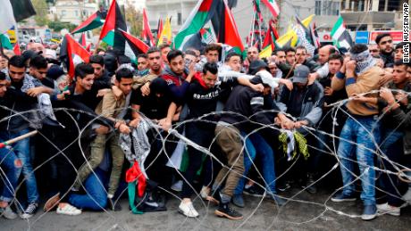 Protestors try to remove a  barbed wire fence outside of US embassy in Beirut.