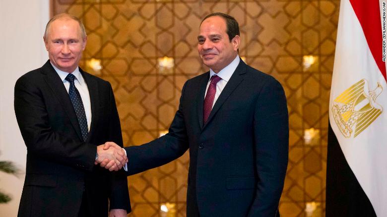 Putin (L) and Sisi shake hands during their meeting in Cairo on Monday.