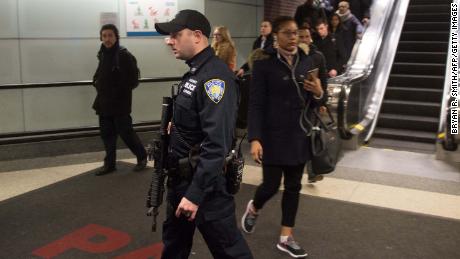 Port Authority police watch as people evacuate after an explosion at the Port Authority bus terminal on Monday in New York.  