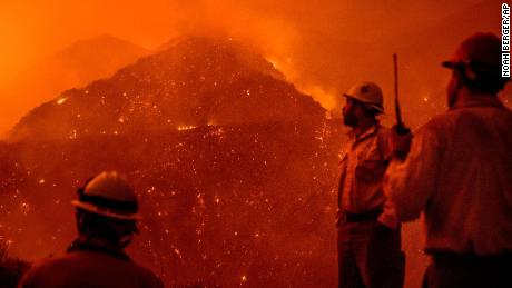 Firefighters monitor the Thomas fire as it burns through Los Padres National Forest.