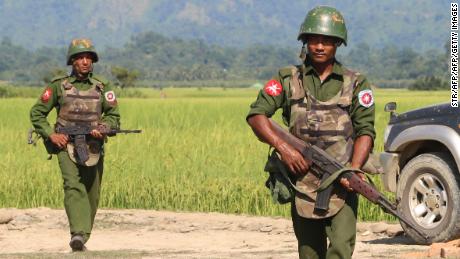 In this photograph taken on October 21, 2016, armed Myanmar army soldiers patrol a village in Maungdaw, Rakhine State following the October 9, 2016 attacks.