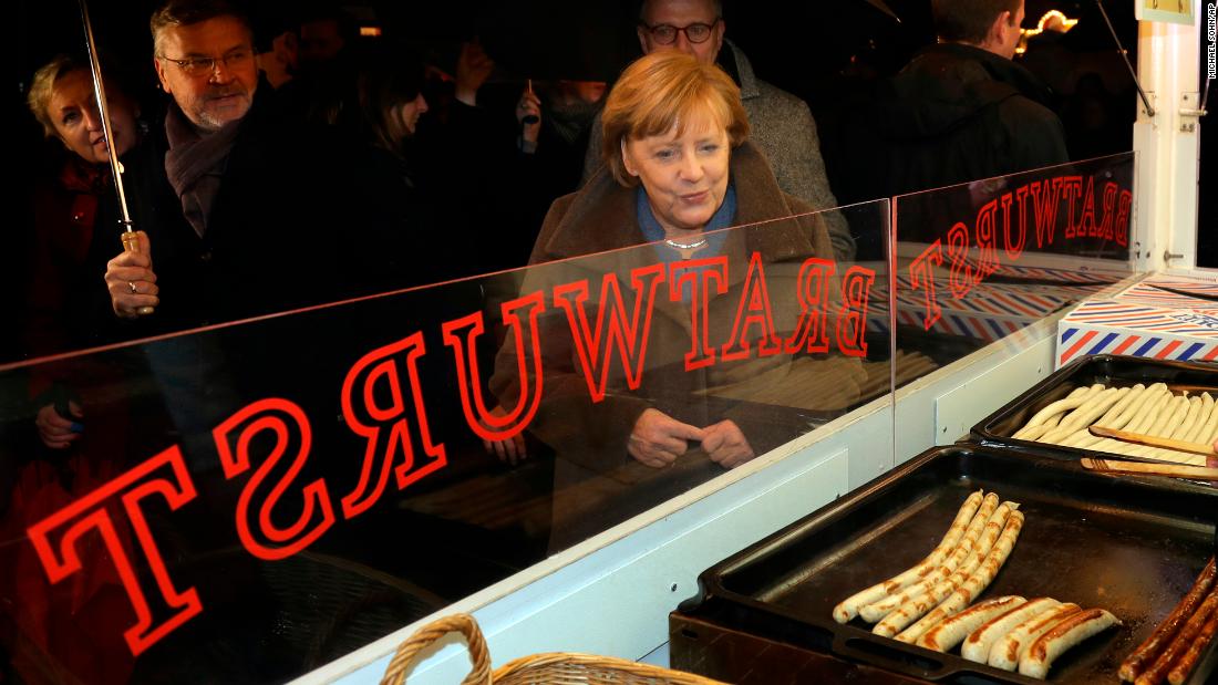 German Chancellor Angela Merkel leaves a sausage stall as she visits a Christmas market in Berlin on Tuesday, December 12. The market was the site of &lt;a href=&quot;http://www.cnn.com/2016/12/20/europe/berlin-christmas-market-attack-witnesses/index.html&quot; target=&quot;_blank&quot;&gt;a deadly terrorist attack&lt;/a&gt; one year ago.