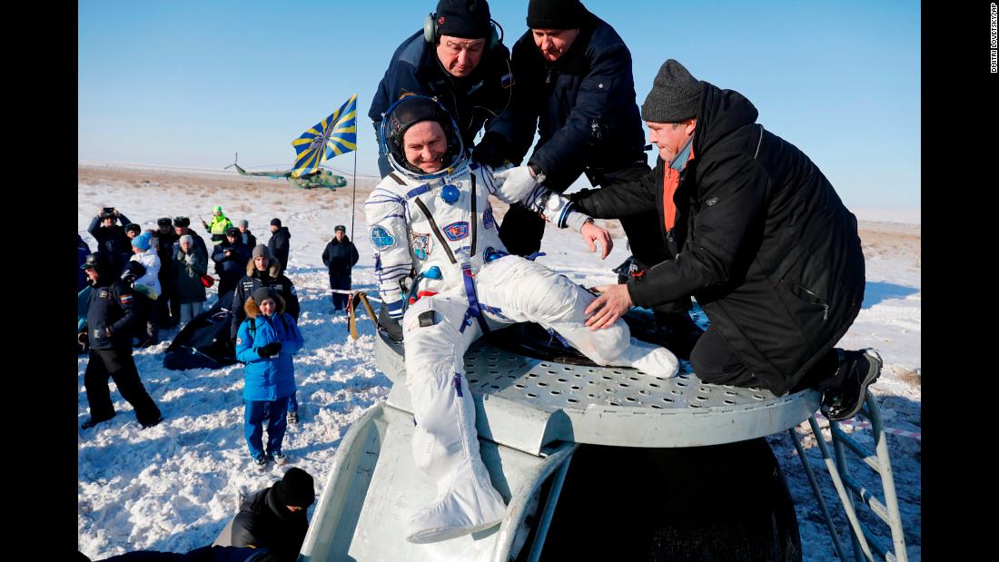 Russian cosmonaut Sergey Ryazansky is helped out of a space capsule after landing in Zhezkazgan, Kazakhstan, on Thursday, December 14. He and two others landed back on Earth after spending nearly six months aboard the International Space Station.