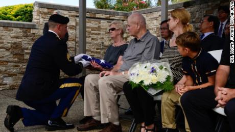A soldier presents a burial flag to the next of kin of US Army Pfc. Albert E. Atkins on Friday at the National Memorial Cemetery of the Pacific in Honolulu, Hawaii. 
