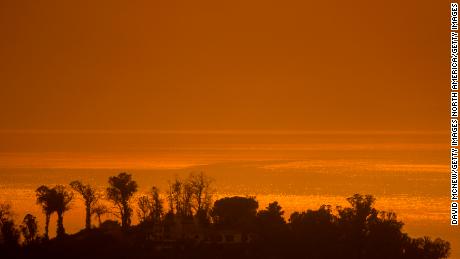Smoke fills the sky over the ocean beyond homes threatened by the Thomas Fire on December 16, 2017 in Montecito, California.