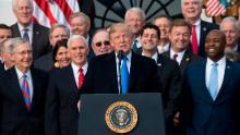 US President Donald Trump flanked by Republican lawmakers speaks about the passage of tax reform legislation on the South Lawn of the White House in Washington, DC, December 20, 2017.
Trump hailed a &quot;historic&quot; victory Wednesday as the US Congress passed a massive Republican tax cut plan, handing the president his first major legislative achievement since taking office nearly a year ago. / AFP PHOTO / SAUL LOEB        (Photo credit should read SAUL LOEB/AFP/Getty Images)