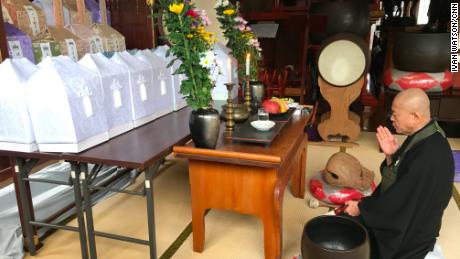 Ryosen Kojima, a priest at Tousenji Temple, says prayers for the recently deceased, including 15 North Koreans who died on fishing boats that washed up on the Oga Peninsula. 