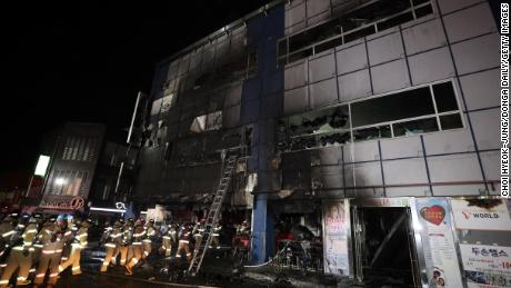 Firefighters make their way into a building on December 21, 2017 in Jecheon, South Korea. 