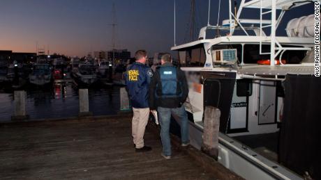 AFP officers stand next to a vessel in the Port of Geraldton, WA.