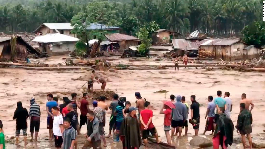 Villagers cross raging floodwaters December 22 in Lanao del Norte province in the southern Philippines in this photo made from video by Aclimah Disumala. 