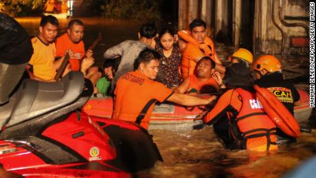 Rescue workers evacuate flood-affected residents in Davao on the southern Philippine island of Mindanao after Tropical Storm Tembin dumped torrential rains across the island.