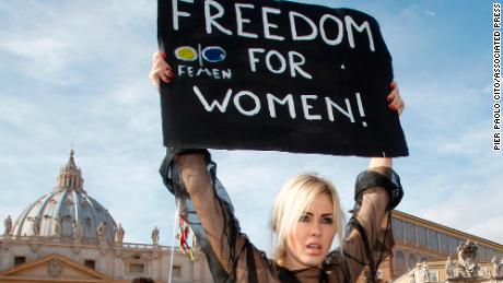 An activist of the Ukrainian female rights organization "Femen" shows a placard during a protest in St. Peter's Square at the Vatican, Sunday, Nov. 6, 2011. (AP Photo/Pier Paolo Cito)