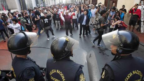 Police and protesters face off during a rally against the pardoning of Alberto Fujimori on Monday.