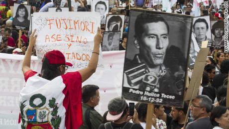 Demonstrators march in Lima on Monday to protest the presidential pardon for Fujimori.