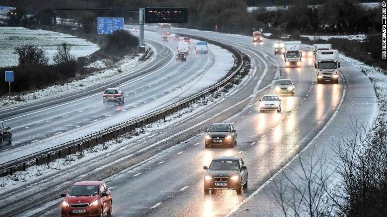 In Britain, snow reduces the M5 motorway down to two lanes between junction 14 and 15 in South Gloucestershire after snow caused travel disruptions across parts of the UK. 
