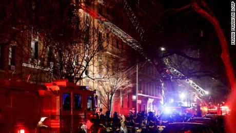 Firefighters respond to a building fire Thursday, December 28 in the Bronx borough of New York. The Fire Department of New York says a blaze raging in the Bronx apartment building has seriously injured more than a dozen of people.