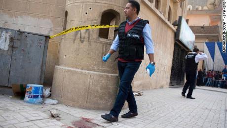 Security officials inspect the damage at the St. Mina Coptic church on Friday. 