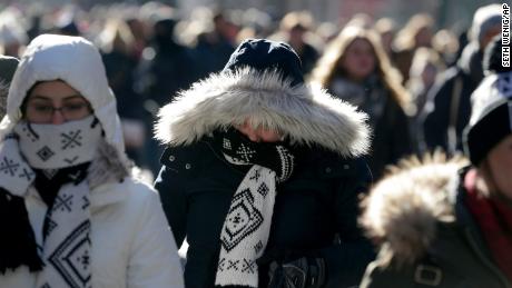 People try to keep warm in New York&#39;s Times Square on Wednesday, December 27.