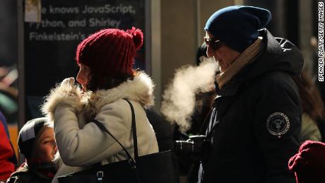 People walk through a frigid Manhattan on December 28, 2017 in New York City. Dangerously low temperatures and wind chills the central and eastern United States are making outdoor activity difficult for many Americans.  Little relief from the below normal temperatures is expected the first week of the New Year.   