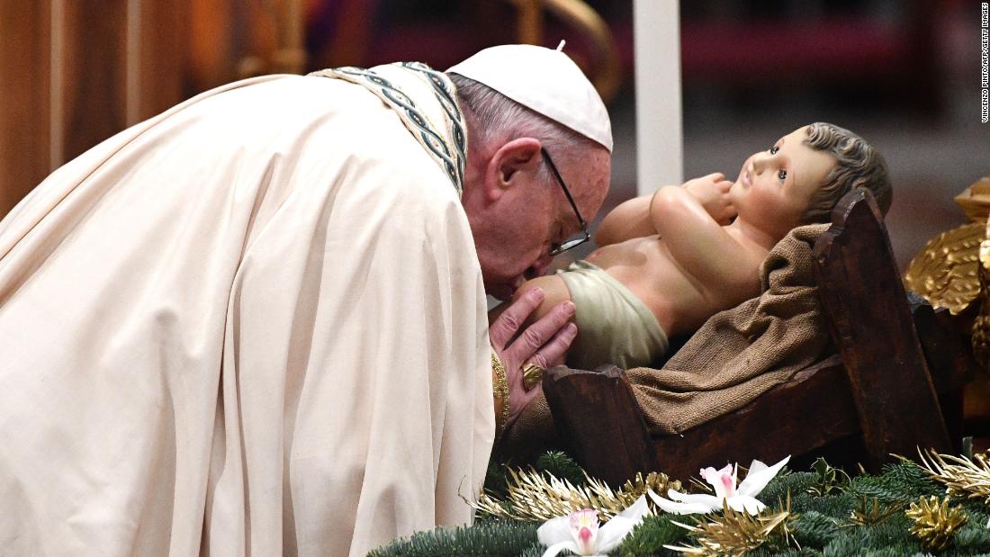Pope Francis kisses the Christ Child upon his arrival to preside over the Te Deum prayer in St, Peter&#39;s Basilica at the Vatican.